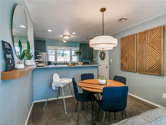 dining area with dark colored carpet