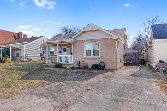 bungalow-style house featuring a porch and a front yard