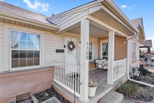 view of exterior entry with covered porch