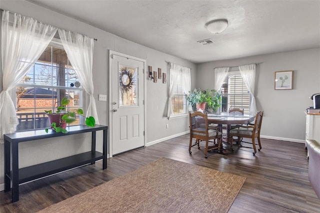 dining area with dark wood-type flooring