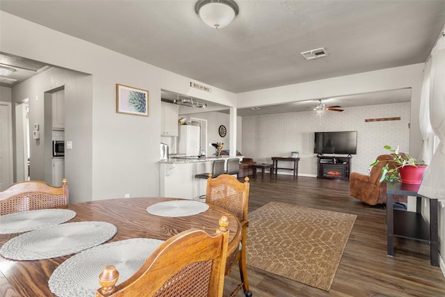 dining area featuring ceiling fan and dark hardwood / wood-style floors