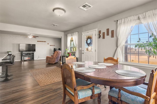 dining area featuring dark wood-type flooring and ceiling fan