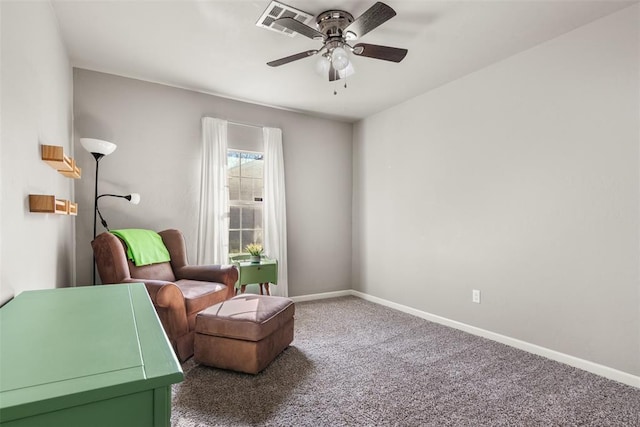 living area with ceiling fan and carpet