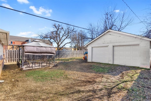 view of yard with a gazebo, a garage, and an outdoor structure