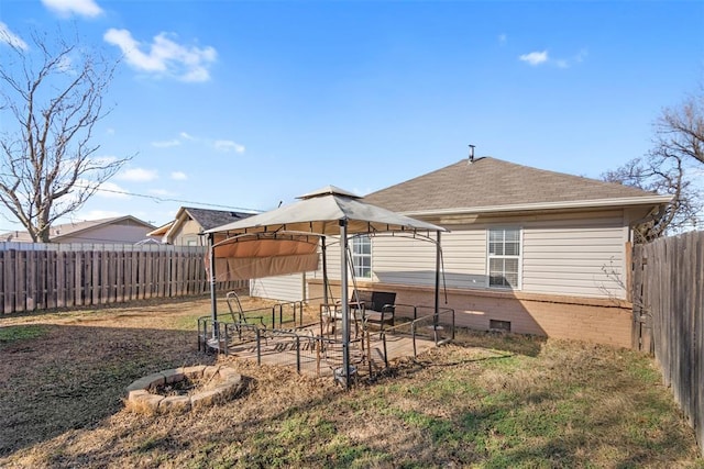 back of property with a gazebo