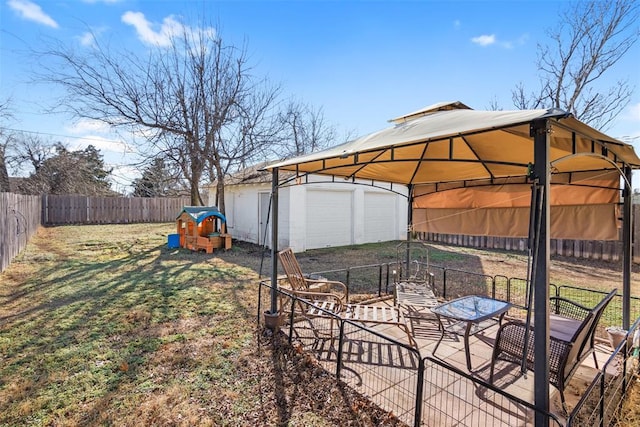 view of yard with a garage and an outbuilding