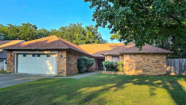 ranch-style home featuring a garage and a front yard