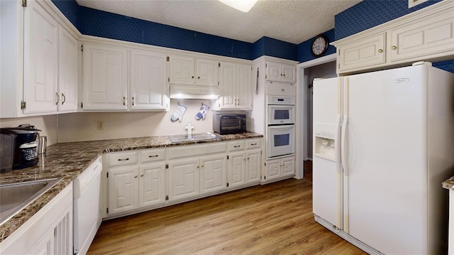 kitchen with sink, white cabinets, white appliances, a textured ceiling, and light wood-type flooring