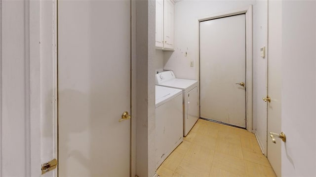 laundry room with independent washer and dryer and cabinets