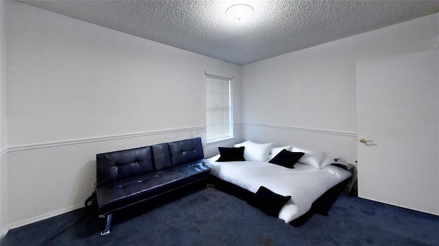 carpeted bedroom featuring a textured ceiling