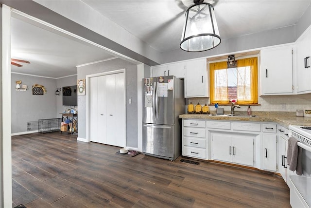 kitchen with sink, stainless steel refrigerator, backsplash, dark hardwood / wood-style floors, and white cabinets