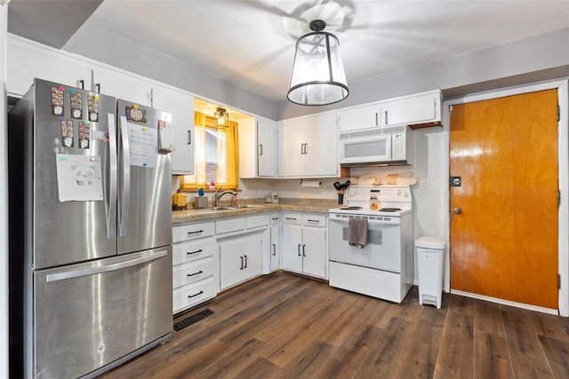 kitchen featuring sink, white appliances, hanging light fixtures, dark hardwood / wood-style floors, and white cabinets