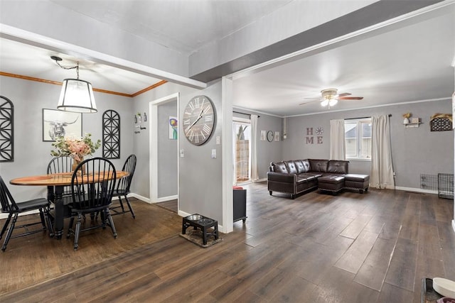 dining room featuring dark wood-type flooring, ceiling fan, and ornamental molding