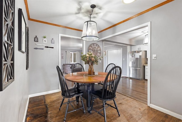 dining room featuring crown molding and hardwood / wood-style floors