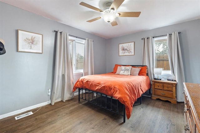 bedroom with ceiling fan and dark hardwood / wood-style floors