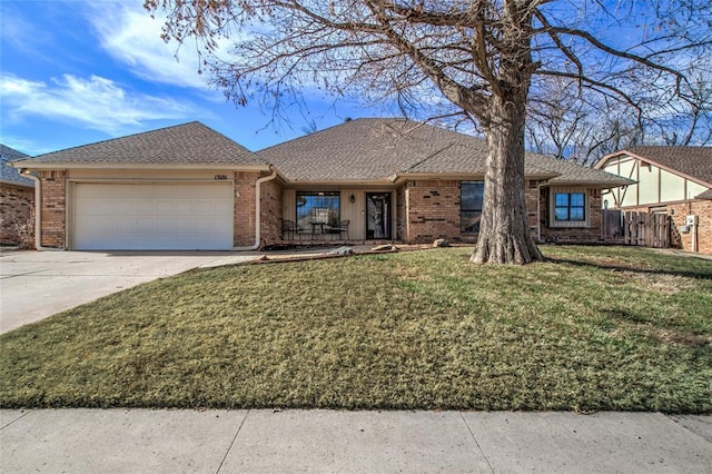 ranch-style house featuring a garage and a front lawn