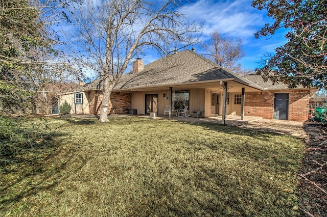 back of house featuring a yard and a patio