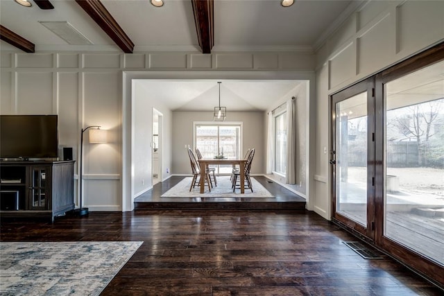 dining room featuring dark hardwood / wood-style flooring and beam ceiling