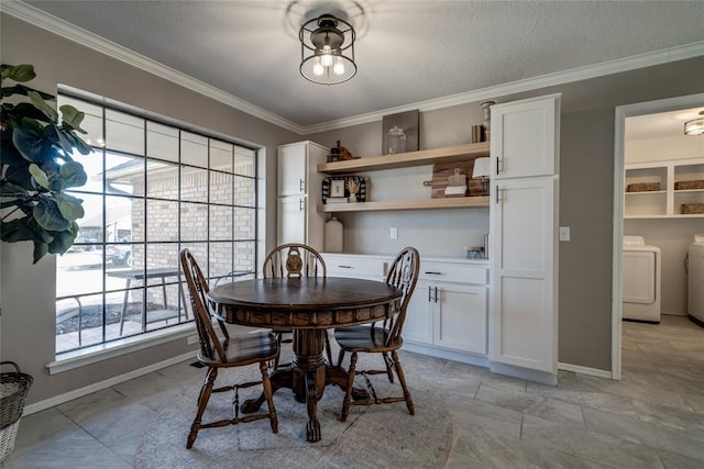 dining area with ornamental molding, washing machine and dryer, and a textured ceiling