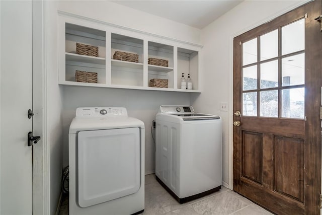 clothes washing area featuring separate washer and dryer