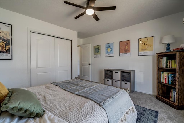 bedroom with ceiling fan, carpet flooring, and a closet