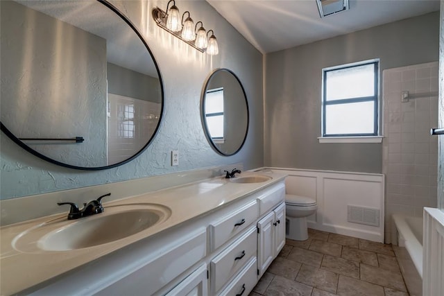 bathroom featuring vanity and toilet