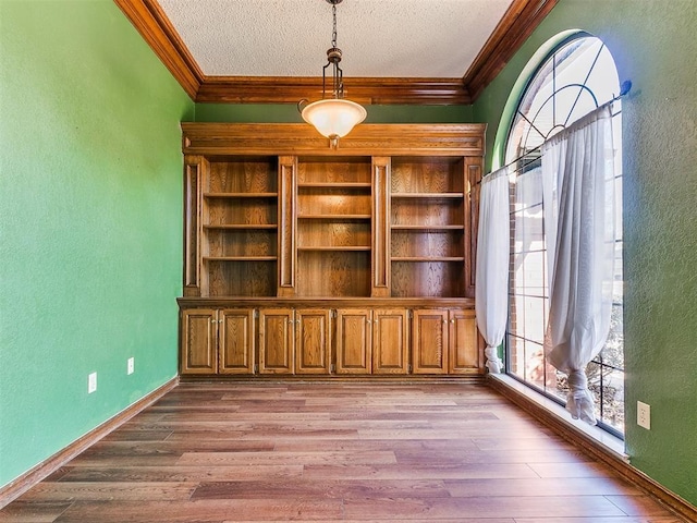 interior space featuring crown molding, a textured ceiling, and light wood-type flooring