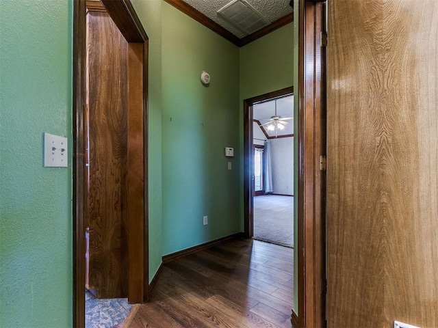 corridor featuring ornamental molding and dark hardwood / wood-style flooring