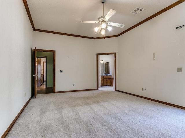 empty room with light colored carpet, ornamental molding, and ceiling fan