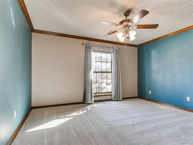 carpeted empty room featuring ceiling fan, crown molding, and a textured ceiling