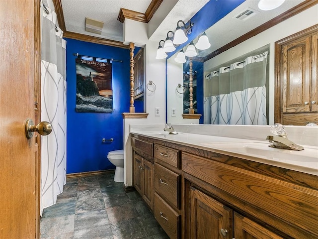 bathroom featuring vanity, crown molding, a textured ceiling, and toilet