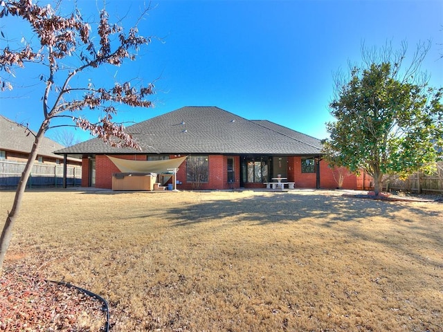 back of property featuring a lawn