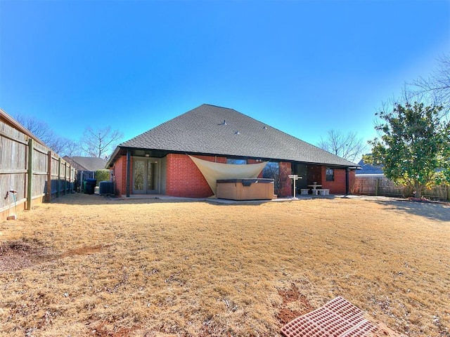 back of house featuring a hot tub, a patio, cooling unit, and french doors