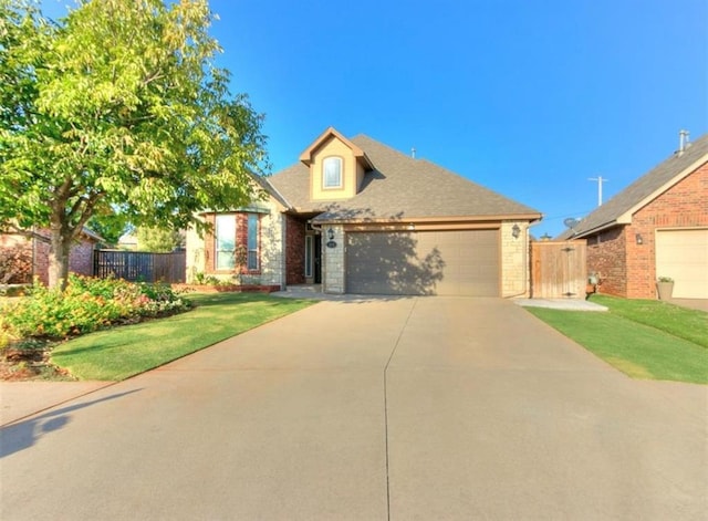 view of front of house with a garage and a front yard