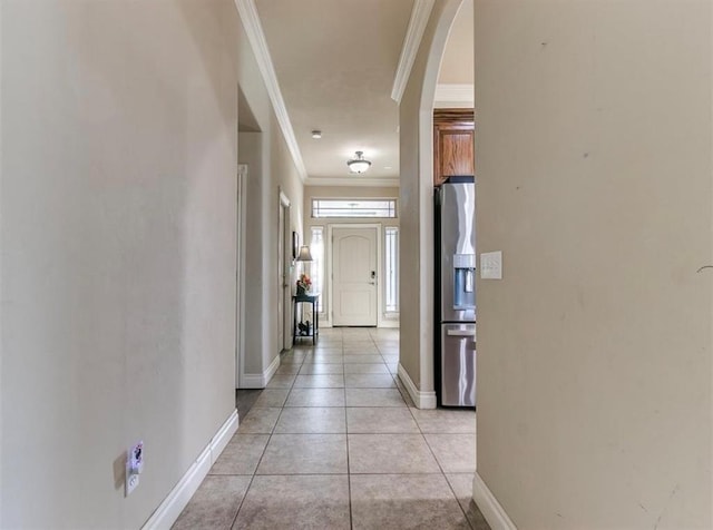 hall featuring ornamental molding and light tile patterned flooring