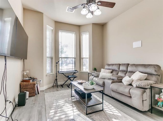 living room with ceiling fan and light hardwood / wood-style floors