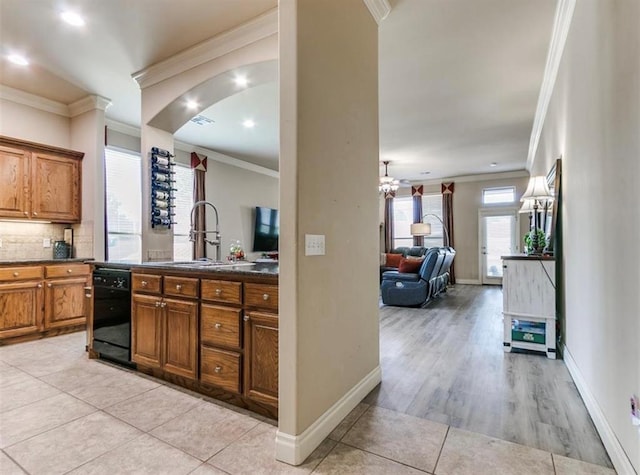 kitchen with dishwasher, sink, backsplash, and crown molding