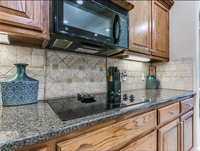 kitchen featuring tasteful backsplash and black appliances