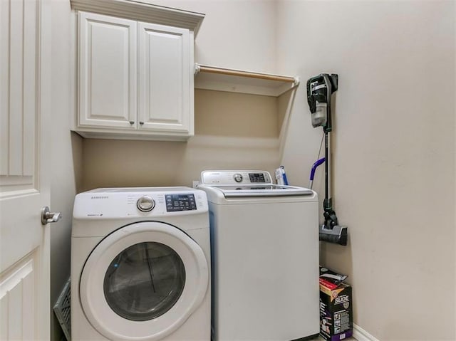 washroom with cabinets and separate washer and dryer