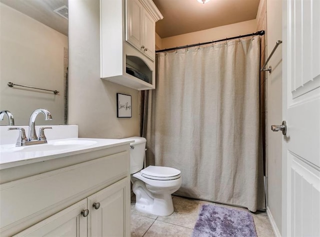 bathroom with vanity, toilet, and tile patterned flooring