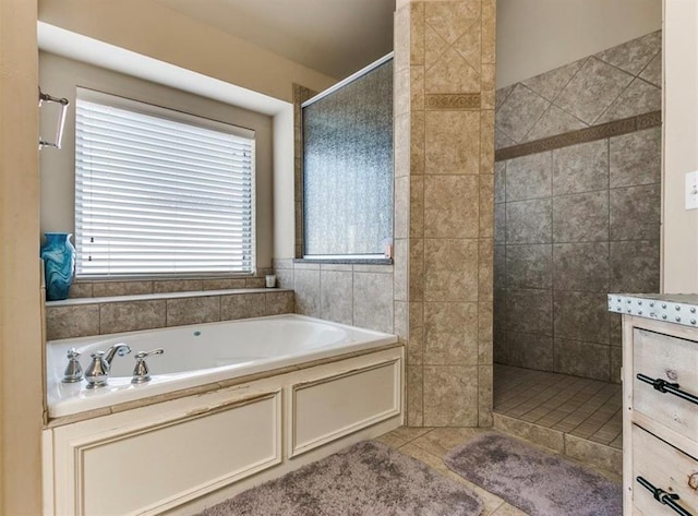 bathroom with tile patterned flooring and independent shower and bath