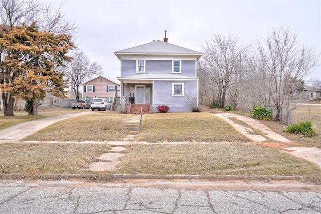 view of front facade featuring covered porch and a front lawn