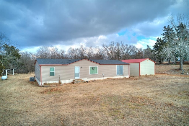 exterior space featuring central AC and a lawn