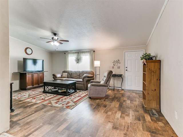 living room with ornamental molding, dark wood-type flooring, and a textured ceiling