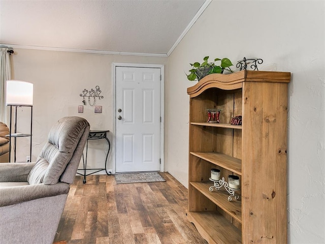 entryway with hardwood / wood-style flooring and ornamental molding