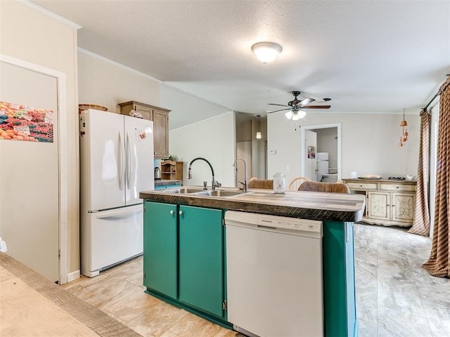 kitchen with sink, white appliances, ceiling fan, green cabinets, and a center island with sink