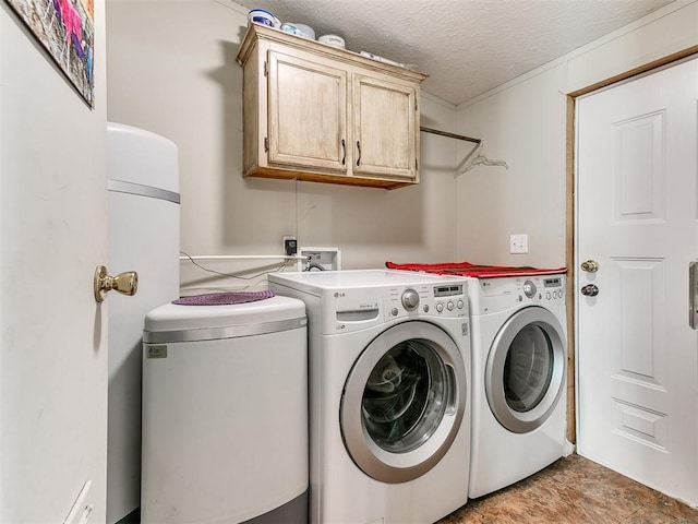 laundry room featuring cabinets, washing machine and dryer, and a textured ceiling