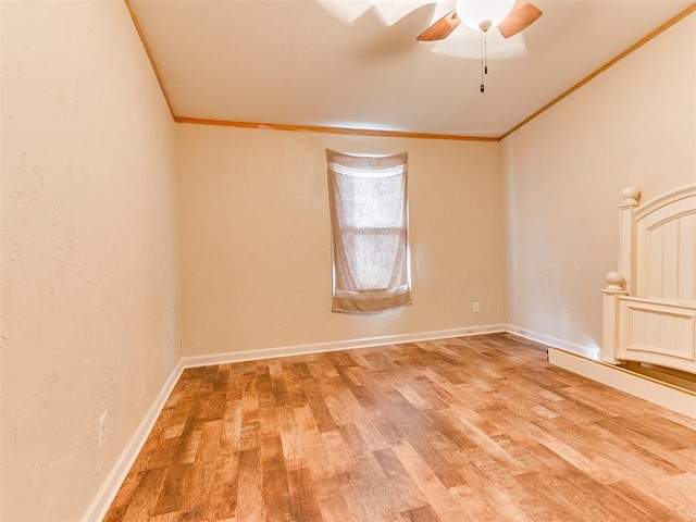 unfurnished room with hardwood / wood-style flooring, crown molding, and ceiling fan