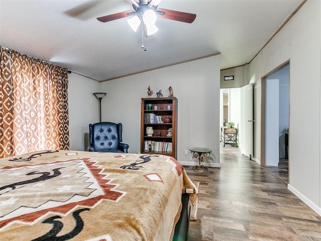 bedroom with ceiling fan, dark hardwood / wood-style floors, and a textured ceiling