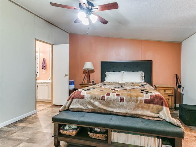 bedroom with a textured ceiling, ceiling fan, and ensuite bathroom